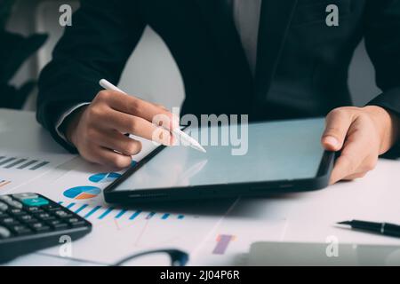 Closeup businessman hand using tablet computer at work Stock Photo
