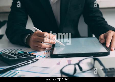 Closeup businessman hand using tablet computer at work Stock Photo