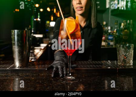 Latin brunette waitress prepares a cocktail at the bar. profession Stock Photo