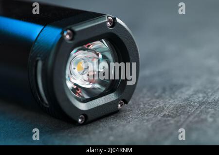 Black Rechargeable Flashlight handheld, LED close-up on a black background Stock Photo