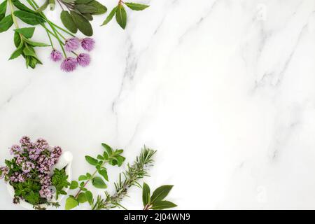 Fresh herb food seasoning for cooking forming an abstract background on marble. Healthy cooking concept. Flat lay, top view, copy space. Stock Photo