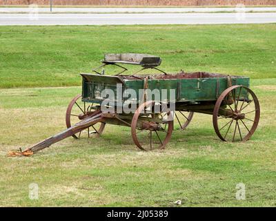 Old green vintage, antique wooden horse drawn wagon from the 1800s in rural Alabama, USA. Stock Photo