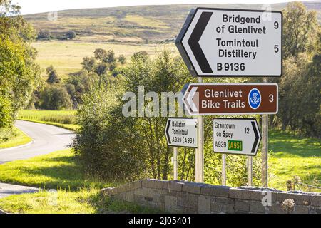 Sign for Glenlivet Bike Trails and Tomintoul Distillery at Bridge of Avon, near Tomintoul, Moray, Scotland UK. Stock Photo