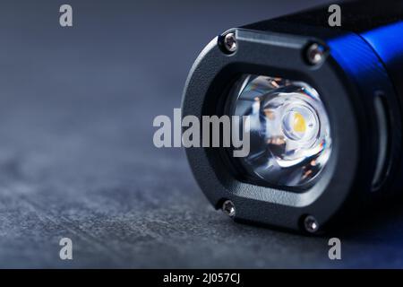 Black Rechargeable Flashlight handheld, LED close-up on a black background Stock Photo
