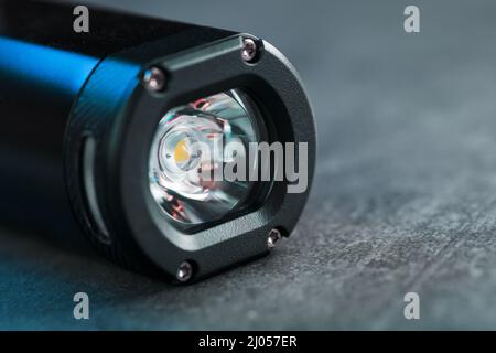 Black Rechargeable Flashlight handheld, LED close-up on a black background Stock Photo
