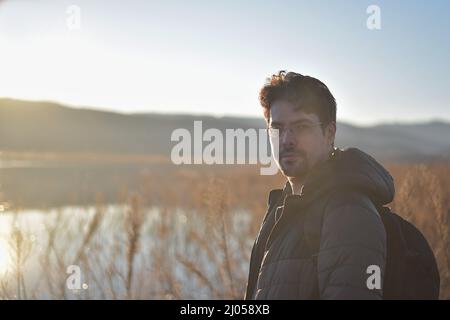portrait of a man with glasses in the sunset Stock Photo
