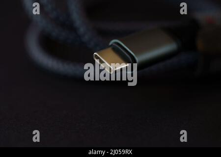 Close up of a usb cable with the Type-C connector located on the keyboard Stock Photo