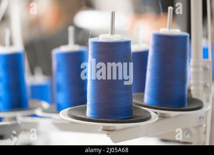 Blue reels of threads industry background, Spools of colored cotton thread, ordered composition Stock Photo