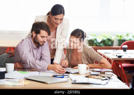 Theyve all got their own views on the new designs. Young creative professionals working in an office. Stock Photo