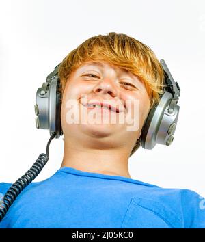 portrait of cute handsome boy listening to music by headphones Stock Photo