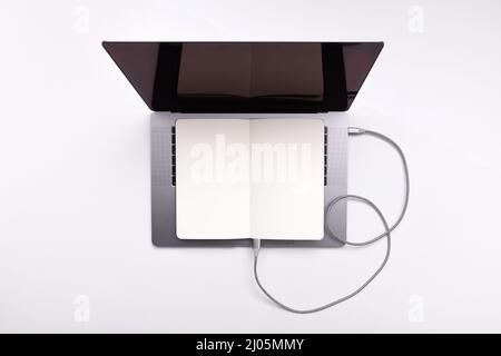 Old and new technology combine concept of transferring data from book to computer Stock Photo