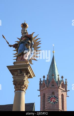 Madonna figure with spire of St. Gallus church on market square in Ladenburg, Baden-Württemberg, Germany Stock Photo