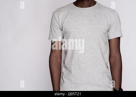 Front view of a black male model wearing a plain grey t-shirt for sale Stock Photo