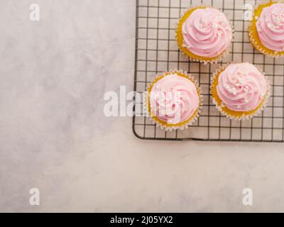 View from above. Muffins with cream on a white background. There is an empty space to insert. Restaurant, confectionery, birthday, buffet, banquet, ad Stock Photo