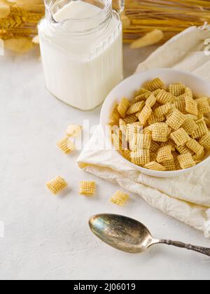 On a white background, whole grain pads, milk. Quick breakfasts, dietary, children's, sports nutrition. Shop, hotel, home cooking, advertising. Stock Photo
