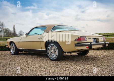 Brummen, Province Gelderland, The Netherlands, 12.03.2022, Rear side view of vintage car Chevrolet Camaro 1975 in yellow colour, second generation Stock Photo