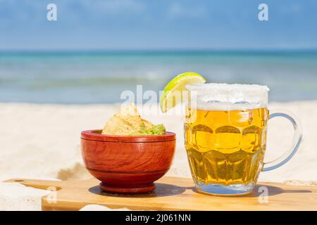 Beer glass and guacamole at mexican beach Stock Photo