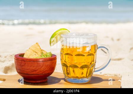 Beer glass and guacamole at mexican beach Stock Photo