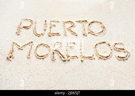 Handwriting words 'Puerto Morelos' on sand of beach Stock Photo