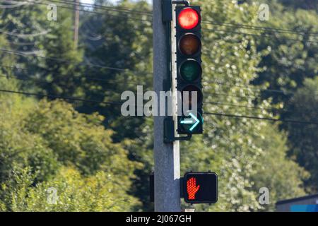 green arrow and red light sign on traffic pole Stock Photo