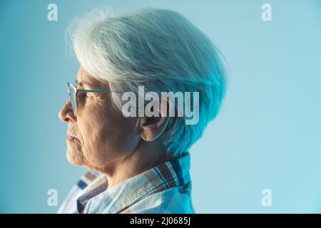 Side portrait of lonely mature caucasian short-haired lady sadly thinking about the future. High quality photo Stock Photo