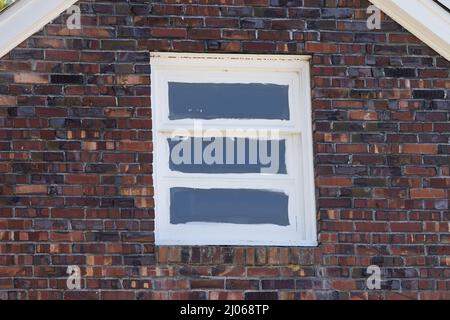 white painted window in brick wall Stock Photo