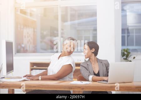 Colleagues and friends. Shot of two female colleagues working together in the same office. Stock Photo