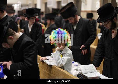 (220316) -- ASHDOD (ISRAEL), March 16, 2022 (Xinhua) -- An ultra-Orthodox child wearing costume for Purim attends a reading of the Megillat Esther during the Jewish holiday of Purim at a synagogue in Ashdod, southern Israel, on March 16, 2022. Purim is a Jewish holiday that commemorates the deliverance of the Jewish people from Haman's plot during the reign of the ancient Persian Empire, according to the Biblical Book of Esther. (Ilan Assayag/JINI via Xinhua) Stock Photo