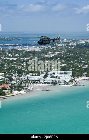 220309-N-IW125-1185 KEY WEST, Fla. (March 9, 2022) A U.S. Army UH-72A Lakota Helicopter attached to the 112th Aviation Regiment flies over Key West, Fla. March 9, 2022. Naval Air Station Key West is the state-of-the-art facility for combat fighter aircraft of all military services, provides world-class pierside support to U.S. and foreign naval vessels, and is the premier training center for surface and subsurface military operations. (U.S. Navy photo by Mass Communication Specialist 2nd Class Nicholas V. Huynh) Stock Photo