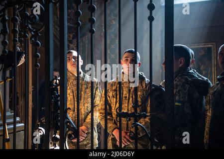 Lviv, Ukraine. 14th Mar, 2022. Ukrainian soldiers stand inside a church during the memorial service for three fallen servicemen. Mourners pay their last respects to three fallen soldiers who were killed in the March 13, 2022, Russian air strike on the Yavoriv military training base. Local authorities reported 35 people were killed and 134 injured at the base, which is close to Ukraine's western border with Poland. (Credit Image: © Laurel Chor/SOPA Images via ZUMA Press Wire) Stock Photo
