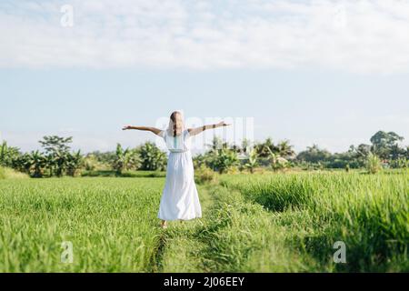 Pregnant women going at the field with green grass and dance with happy face. Sunshine summer vibes Stock Photo
