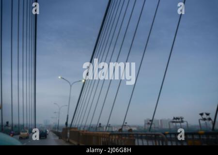 Blurred image of Howrah, West Bengal, India. 2nd Hoogly bridge, vidyasagar setu at blue hour. Monsoon stock image. Stock Photo