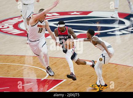 Washington, USA. 16th Mar, 2022. WASHINGTON, DC - MARCH 06: Washington Wizards guard Kentavious Caldwell-Pope (1) drives between Denver Nuggets guard Monte Morris (11) and center Nikola Jokic (15) during a NBA game between the Washington Wizards and the Denver Nuggets, on March 16, 2022, at Capital One Arena, in Washington, DC. (Photo by Tony Quinn/SipaUSA) Credit: Sipa USA/Alamy Live News Stock Photo