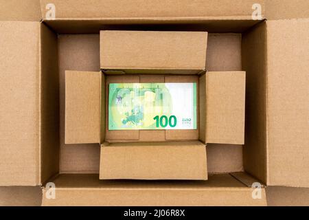 One Hundred Euros banknote in open box made from corrugated cardboard. Stock Photo