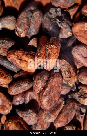 Flat lay macro unpeeled cocoa bean, top view, Whole coco seeds close up texture background Stock Photo