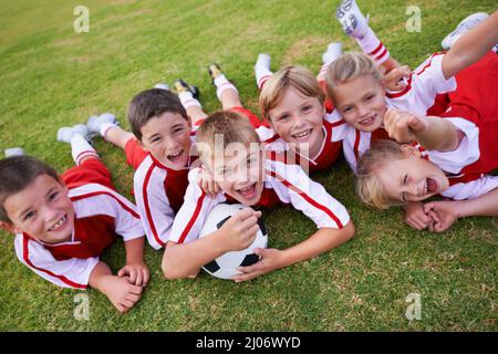 The field holds promise. Shot of a childrens soccer team. Stock Photo