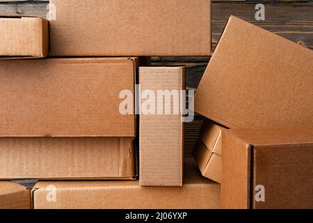 Pile of cardboard boxes on wooden background Stock Photo