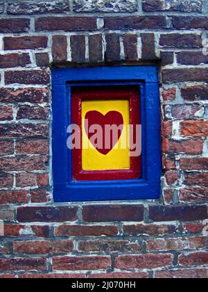 An old window with a heart painted on the wood Stock Photo