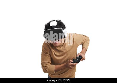 Young peruvian man playing games with joystick and vr headset, isolated. Stock Photo