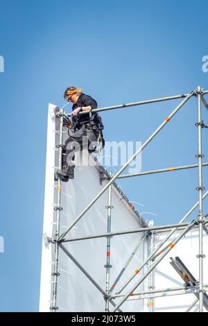 Dordrecht, Netherlands - April 15, 2019: Construction of stage for performance of The Passion. Woman scaffolder constructing scaffolding of temporary Stock Photo