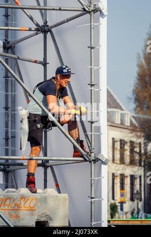 Dordrecht, Netherlands - April 15, 2019: Construction of stage for performance of The Passion. Workman taking brake on the scaffolding of a temporary Stock Photo