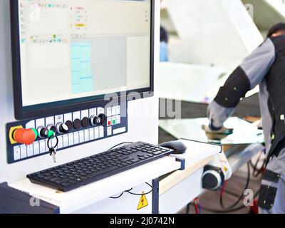 Modern glass cutting machine and worker Stock Photo