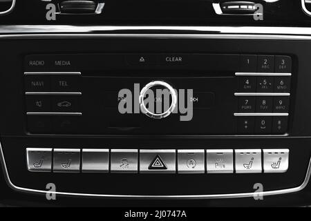 Modern car dashboard with multimedia screen. Interior detail, luxury vehicle close-up view background Stock Photo