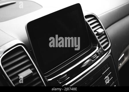 Modern car dashboard with multimedia screen. Interior detail, luxury vehicle close-up view background Stock Photo