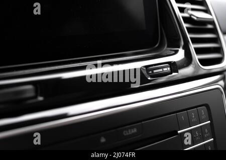 Modern car dashboard with multimedia screen. Interior detail, luxury vehicle close-up view background Stock Photo