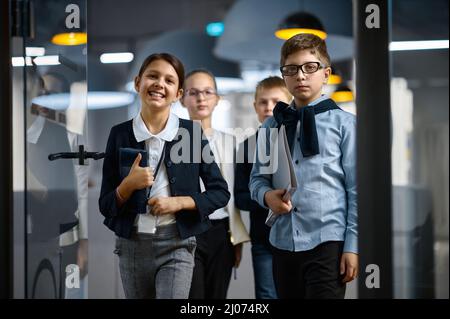 Diverse confident children business group entering office Stock Photo