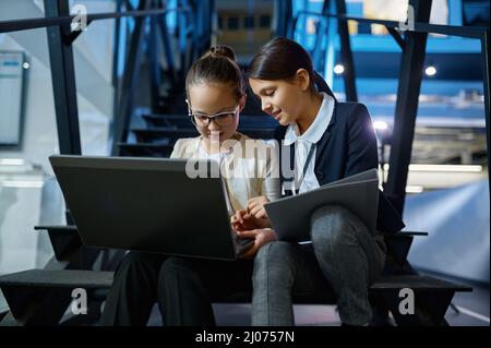 Two business children working together on stairs Stock Photo