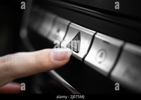 Car emergency light button, triangle car warning button in luxury sport car close-up view Stock Photo