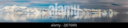 panorama of Paradise Harbour, Antarctica, showing ice-covered mountains and icebergs Stock Photo