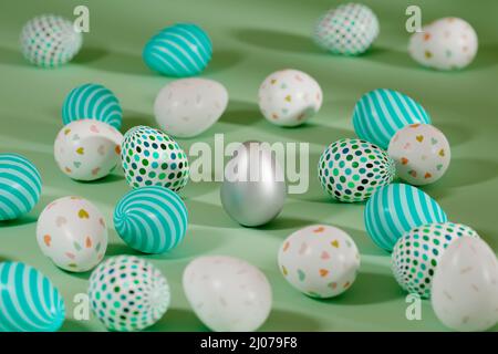 Colored Easter eggs surrounding silver egg on green background. 3d render